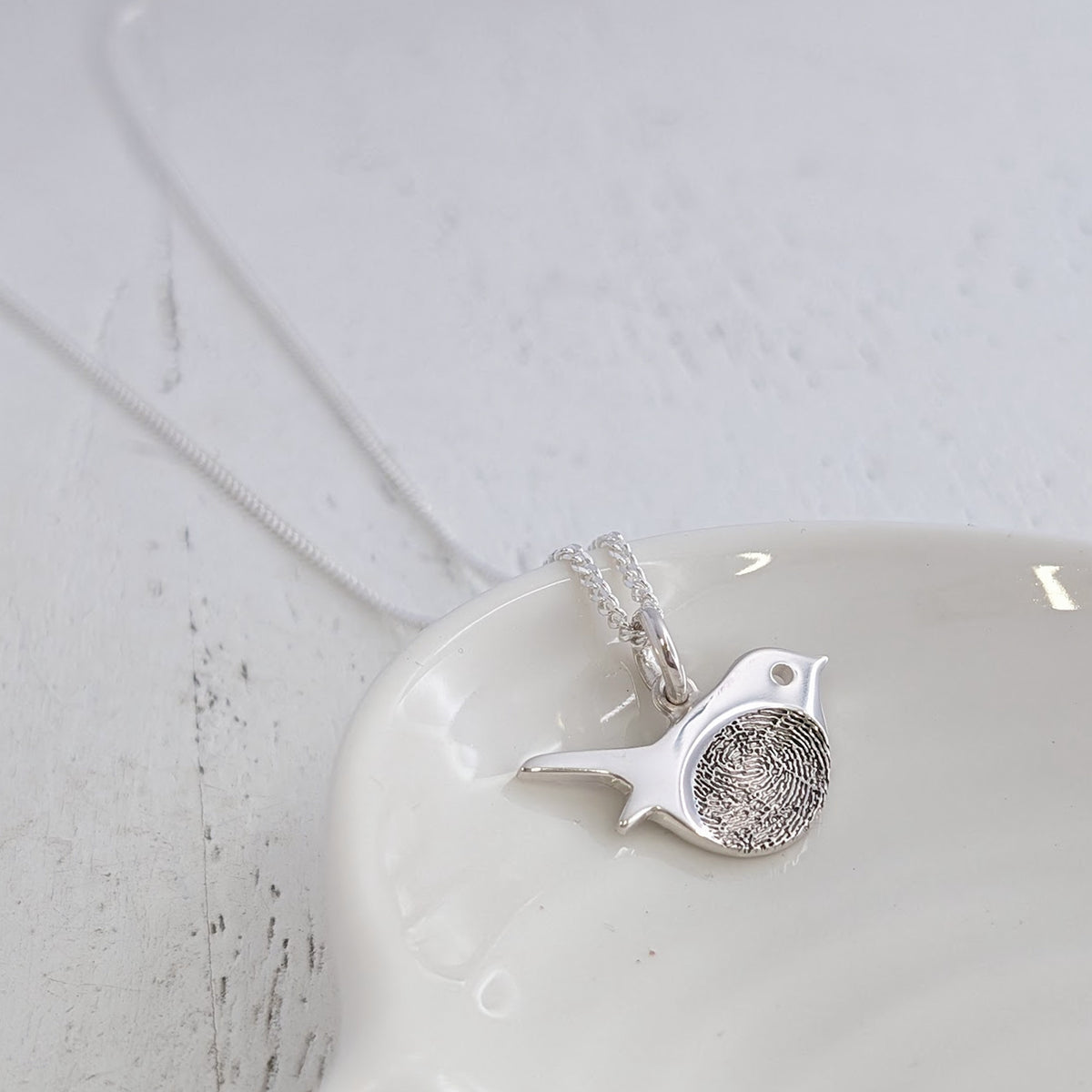 Robin memorial necklace made from silver engraved with your loved one's fingerprint