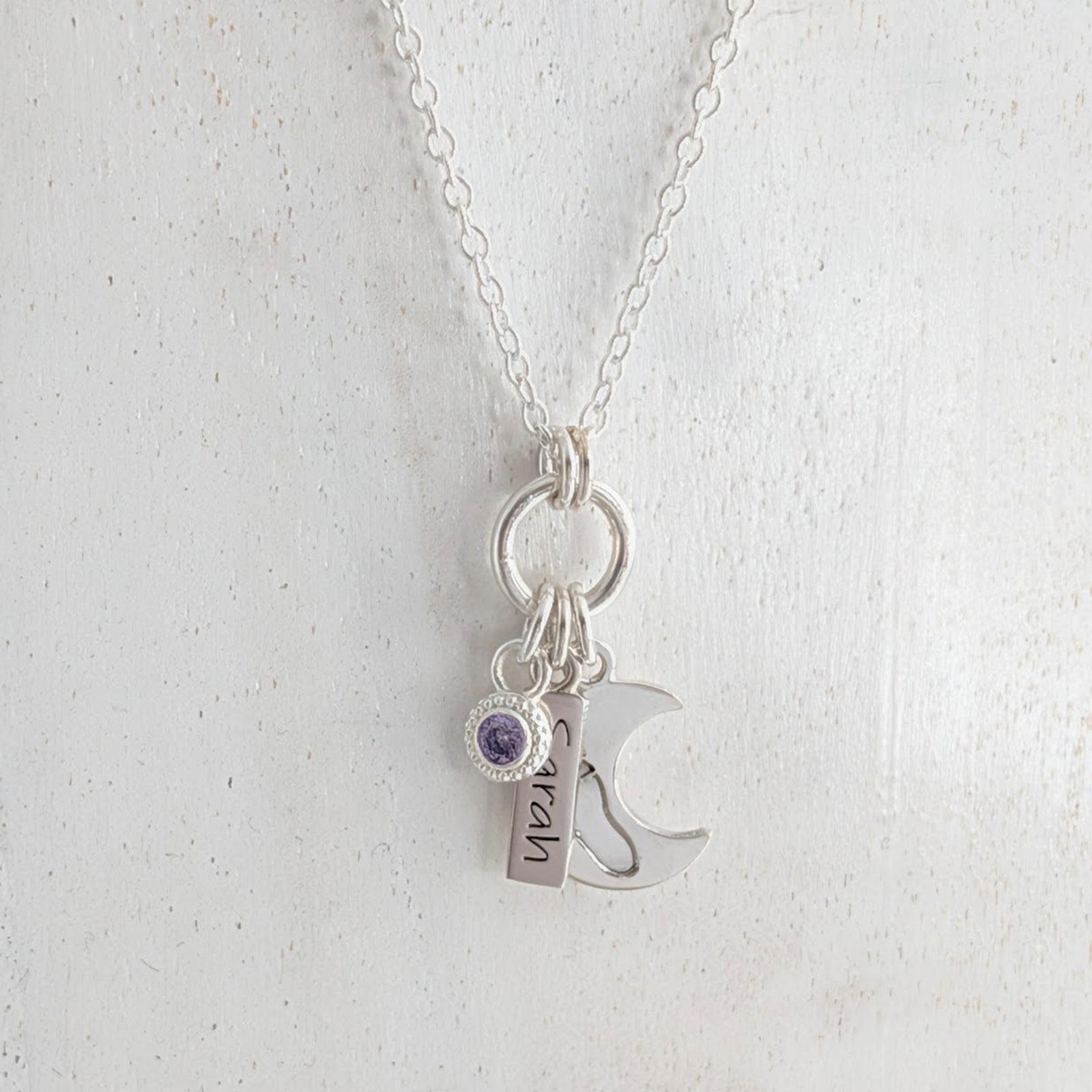 Loved to the moon inspired silver necklace engraved with child's own handprint or footprint and birthstone.