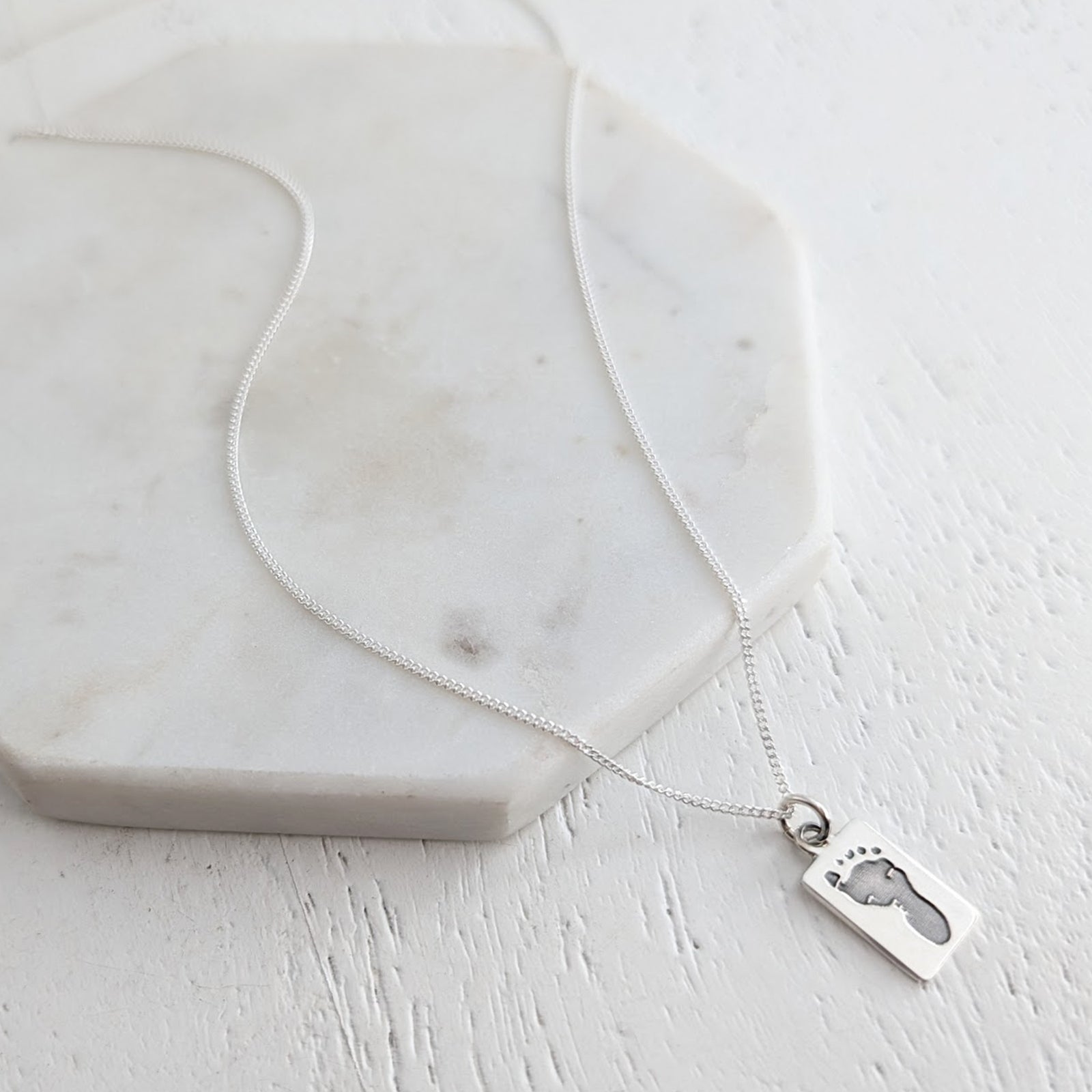 Silver necklace with baby footprint pendant. Baby Handprint Keepsake Jewellery UK