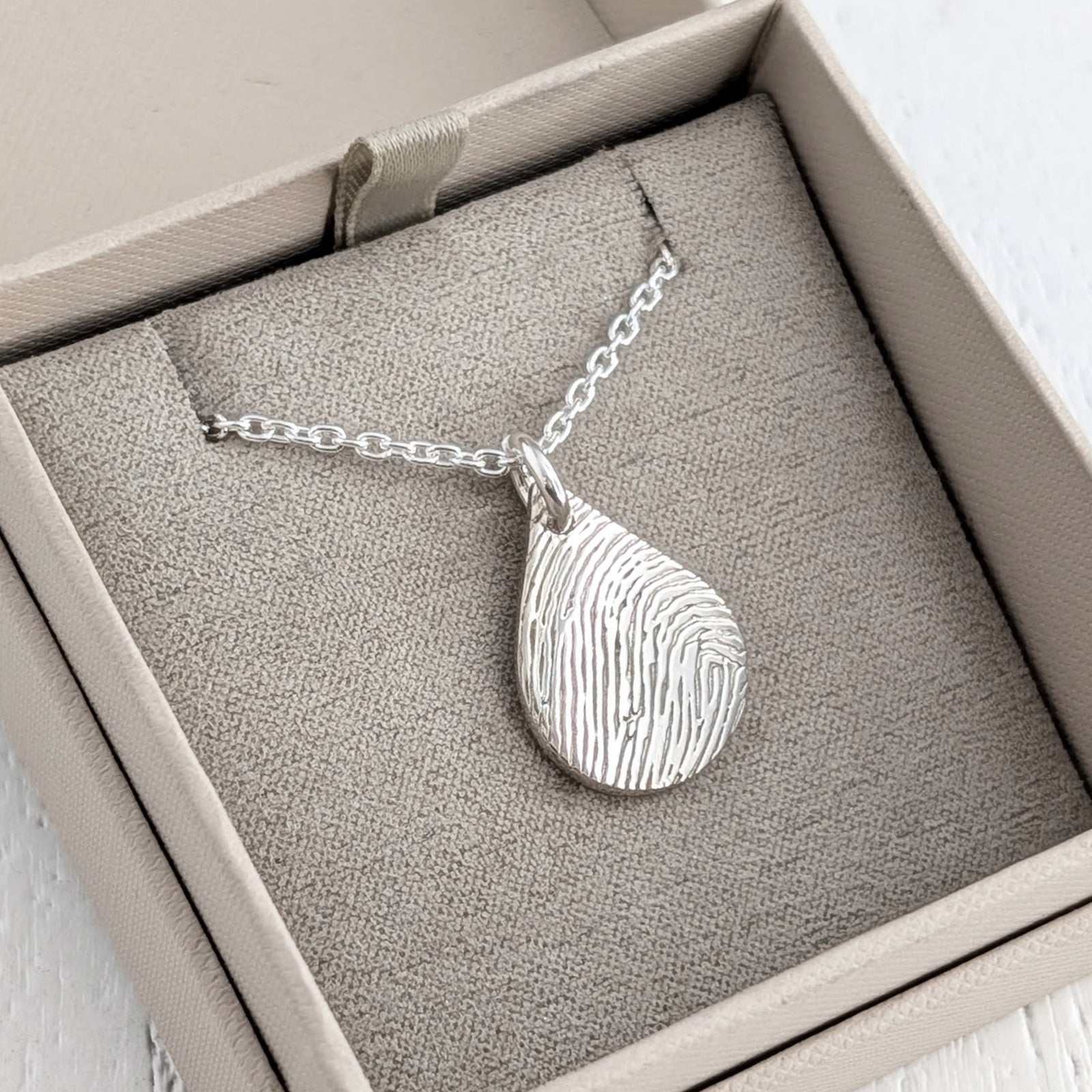 Silver dewdrop pendant or necklace engraved with a fingerprint
