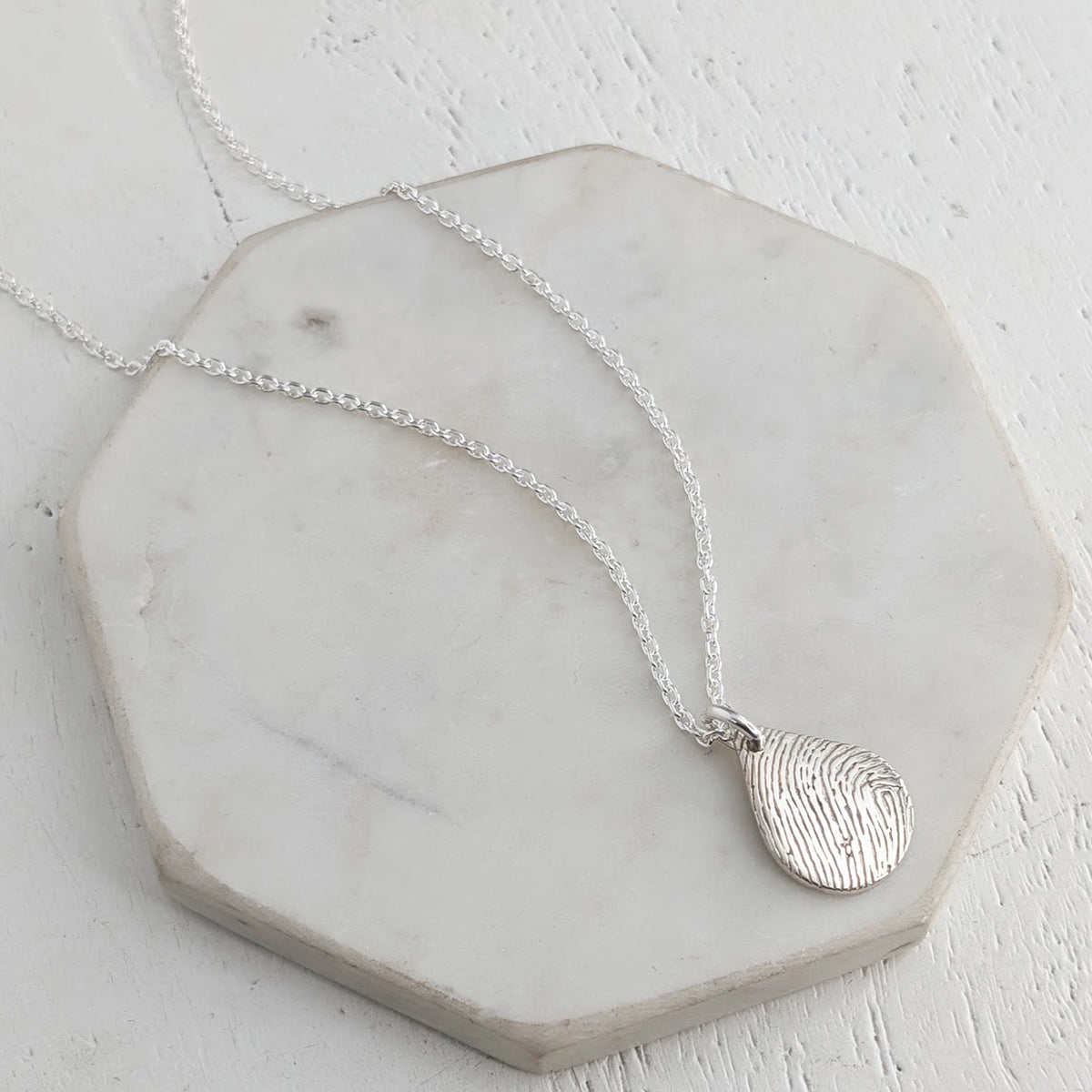Silver peardrop pendant or necklace engraved with a fingerprint
