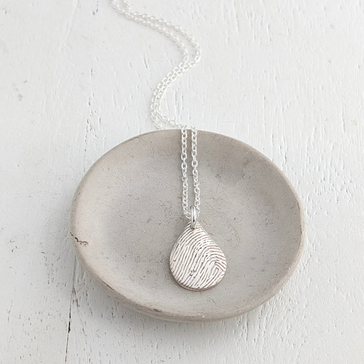 Silver dewdrop pendant or necklace engraved with a fingerprint