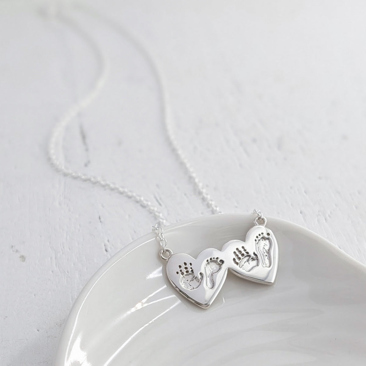 baby handprint and footprint double heart necklace in silver or gold
