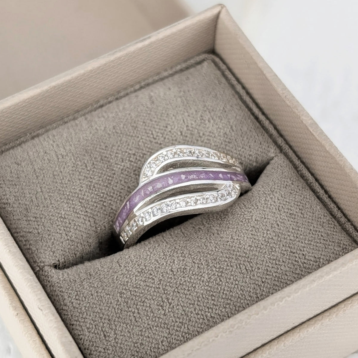 Sterling silver cremation ashes ring with sweeping cubic zirconia design