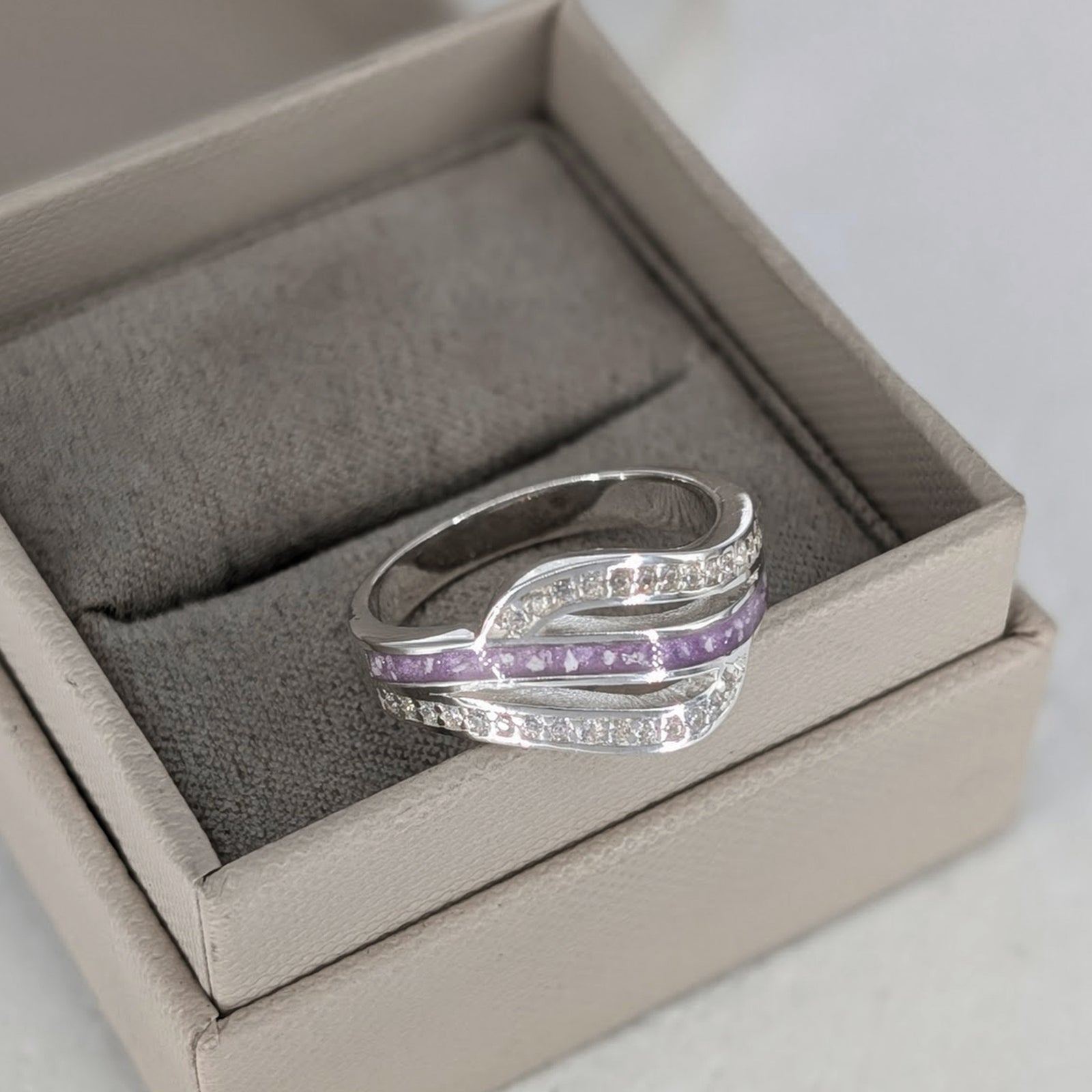Sterling silver cremation ashes ring with sweeping cubic zirconia design