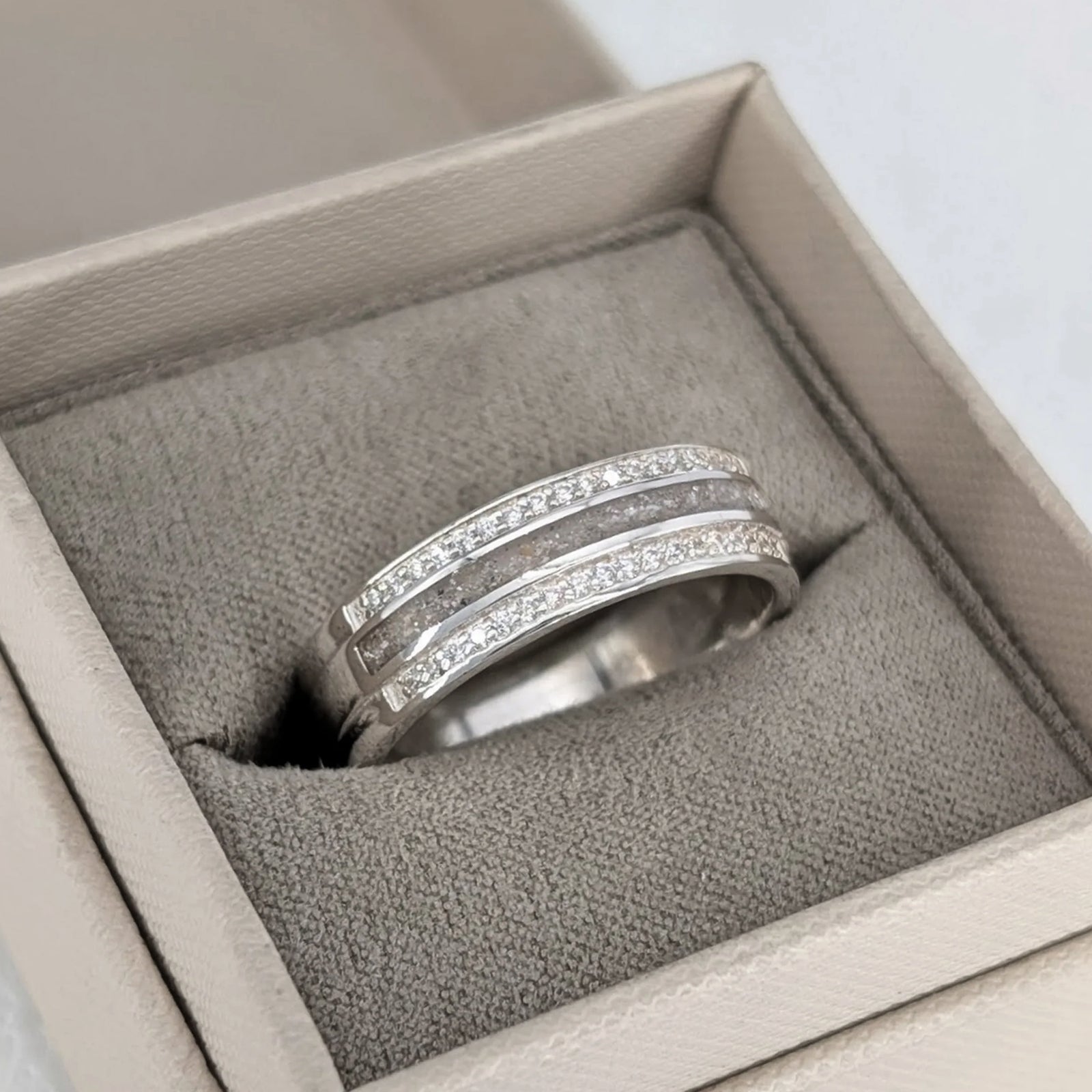 Wide sterling silver ring for loved one’s cremation ashes with sparkling CZ stones