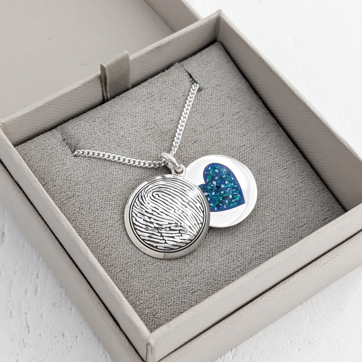 handmade silver fingerprint locket containing memorial cremation ashes