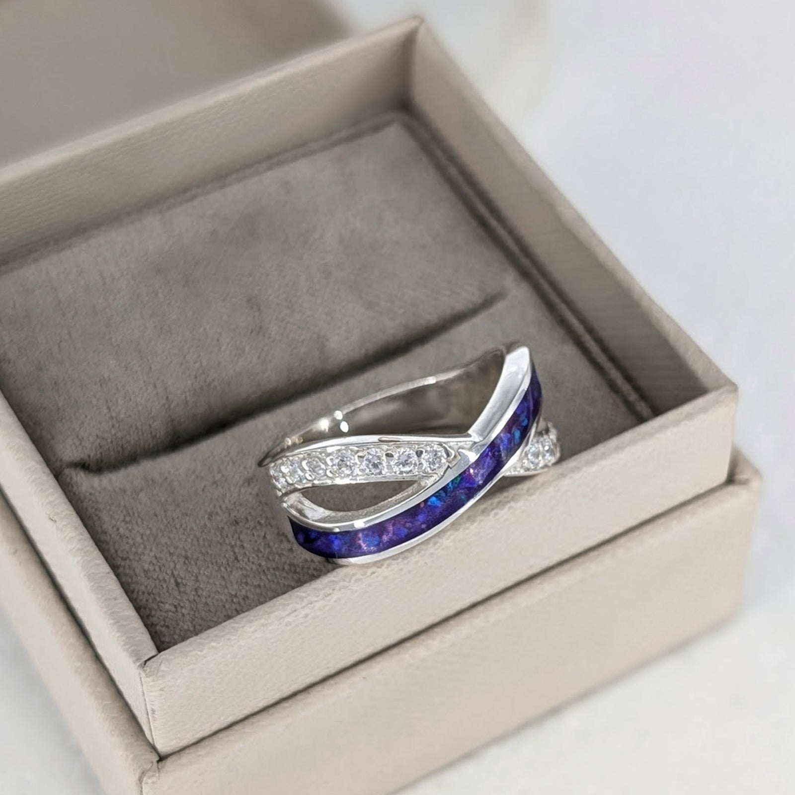 Sterling silver ring for loved one’s cremation ashes with elegant crossover design