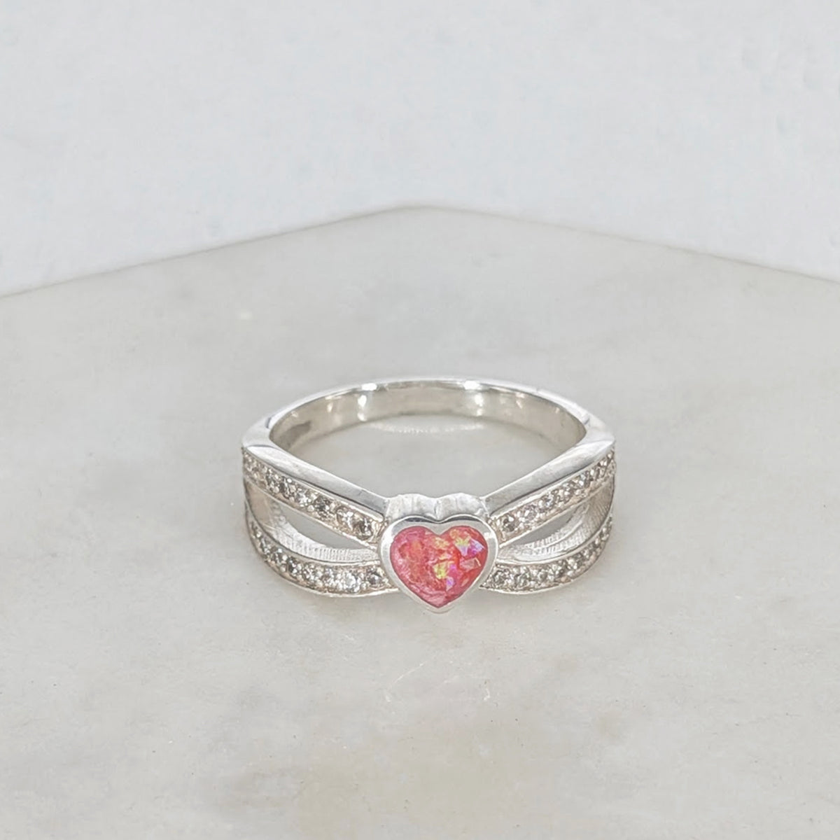 Sterling silver memorial ring for a loved one’s ashes with heart centre and cubic zirconia detail