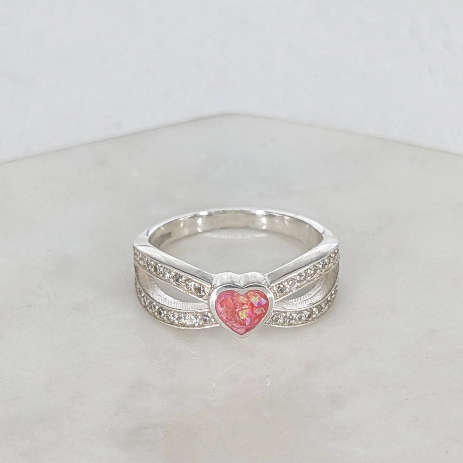 Sterling silver memorial ring for a loved one’s ashes with heart centre and cubic zirconia detail