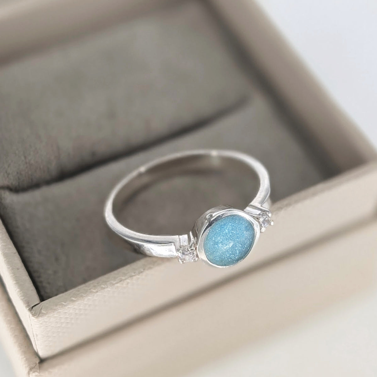 Sterling silver cremation ashes ring with blue opal and sparkling cubic zirconia stones