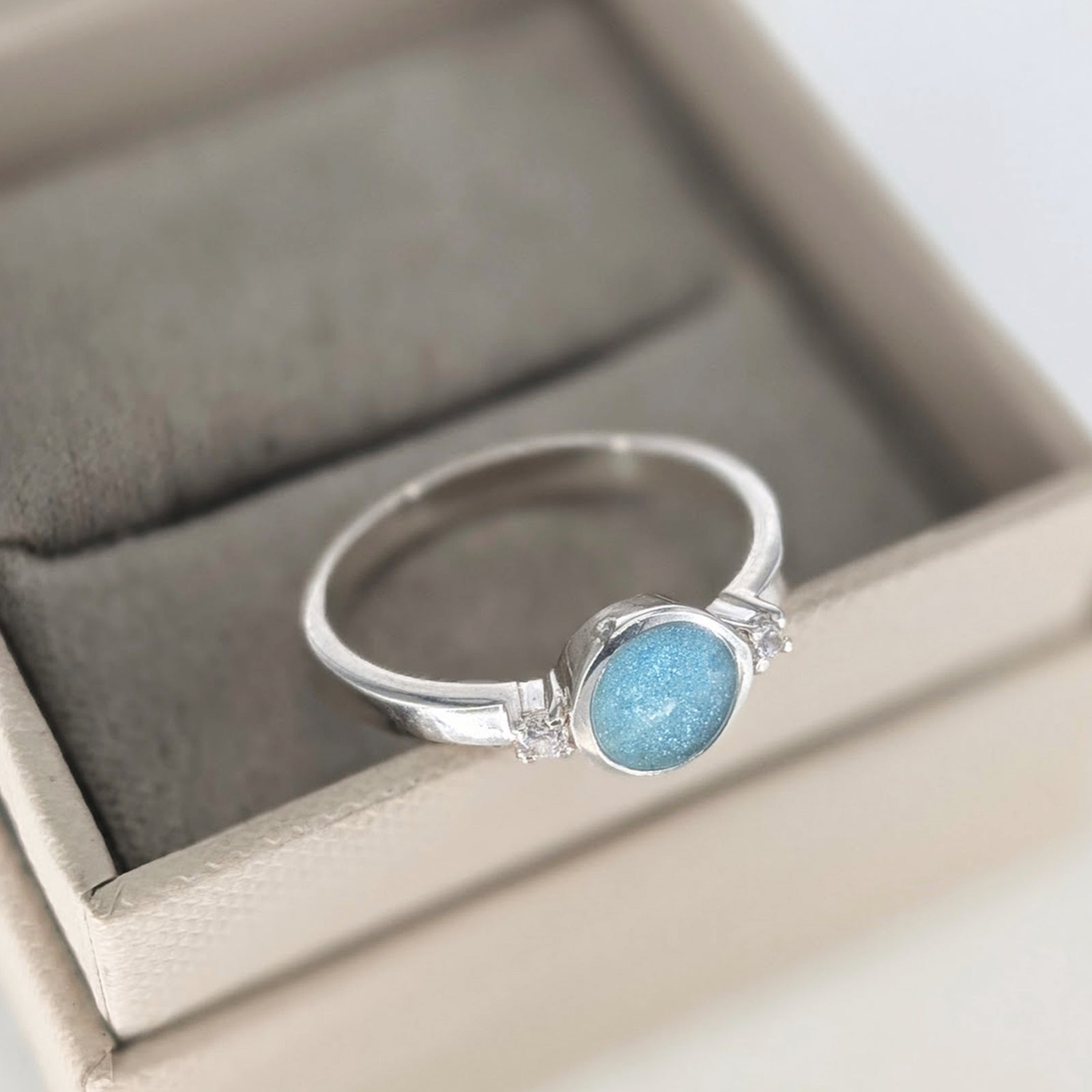 Sterling silver cremation ashes ring with blue opal and sparkling cubic zirconia stones