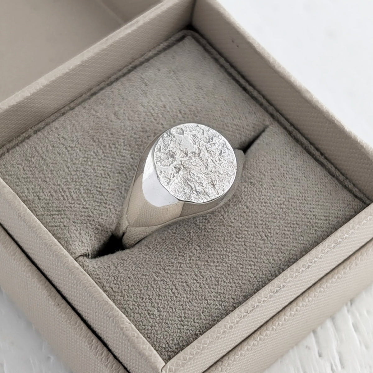 Bereavement ring textured with cremation ashes
