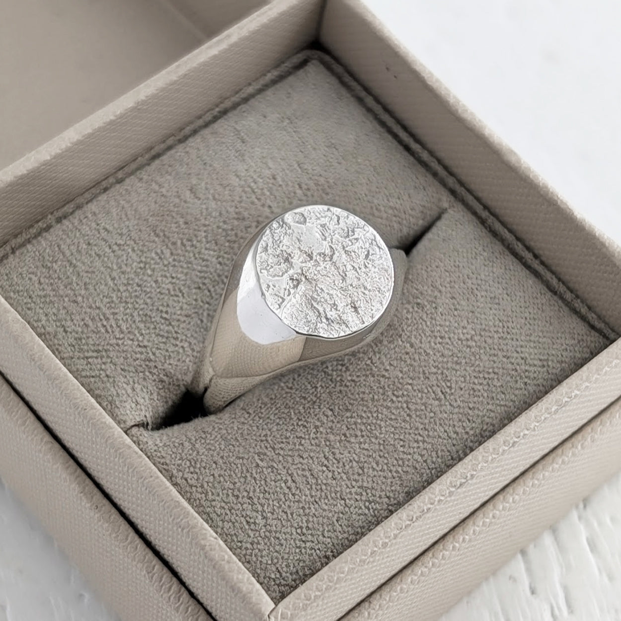 Bereavement ring textured with cremation ashes