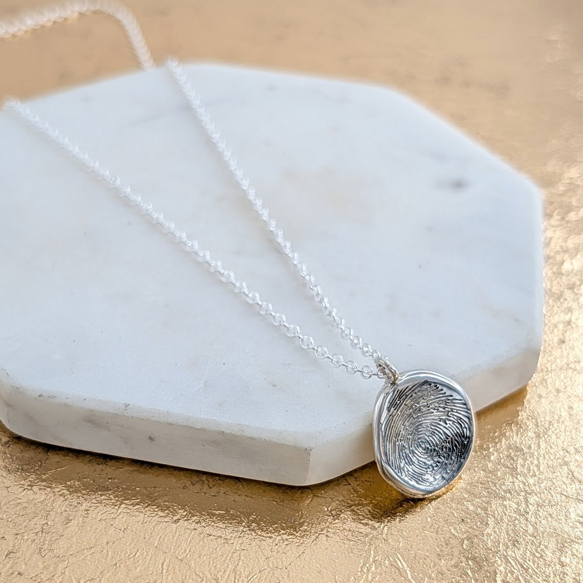 Handcrafted molten silver fingerprint keepsake necklace