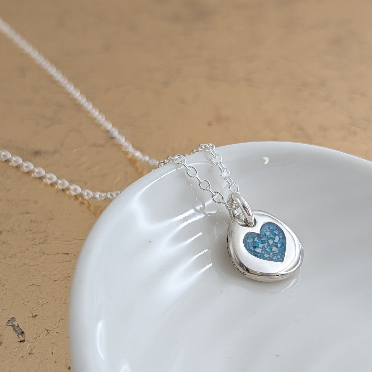 Silver cremation ashes necklace - organic pebble shape with inlaid heart detail