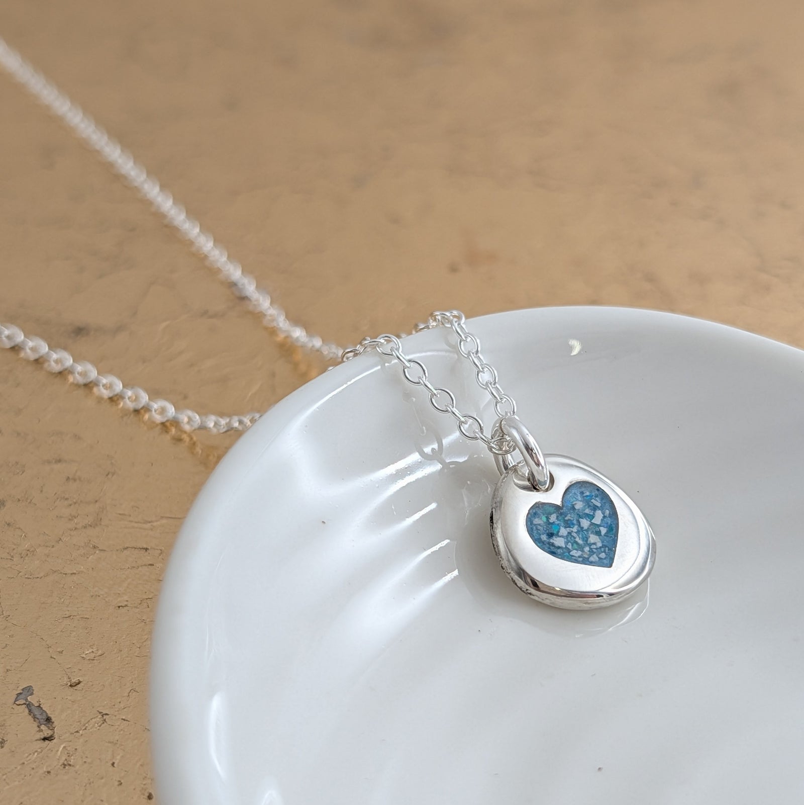 Silver cremation ashes necklace - organic pebble shape with inlaid heart detail
