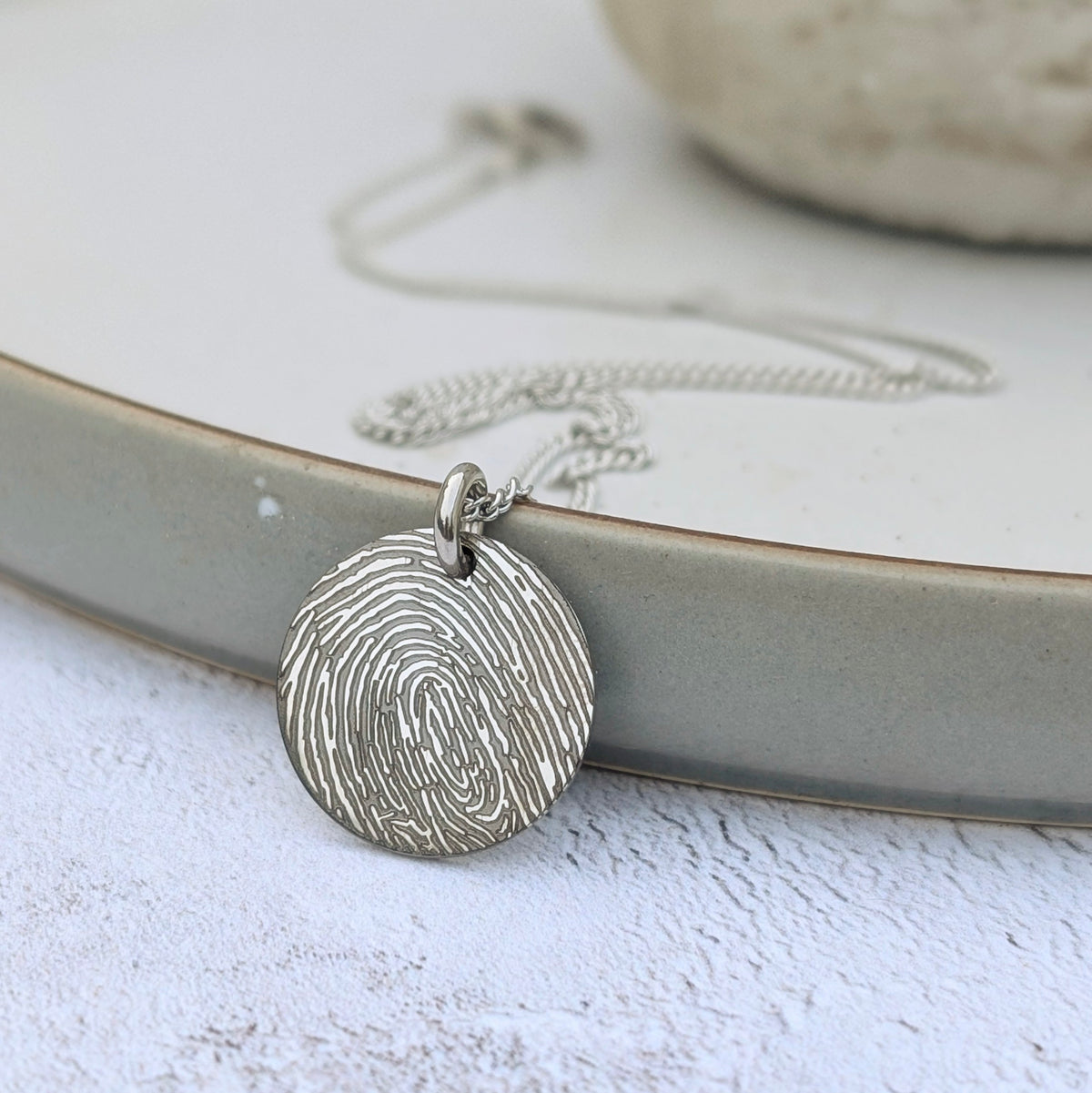 fingerprint disc charm