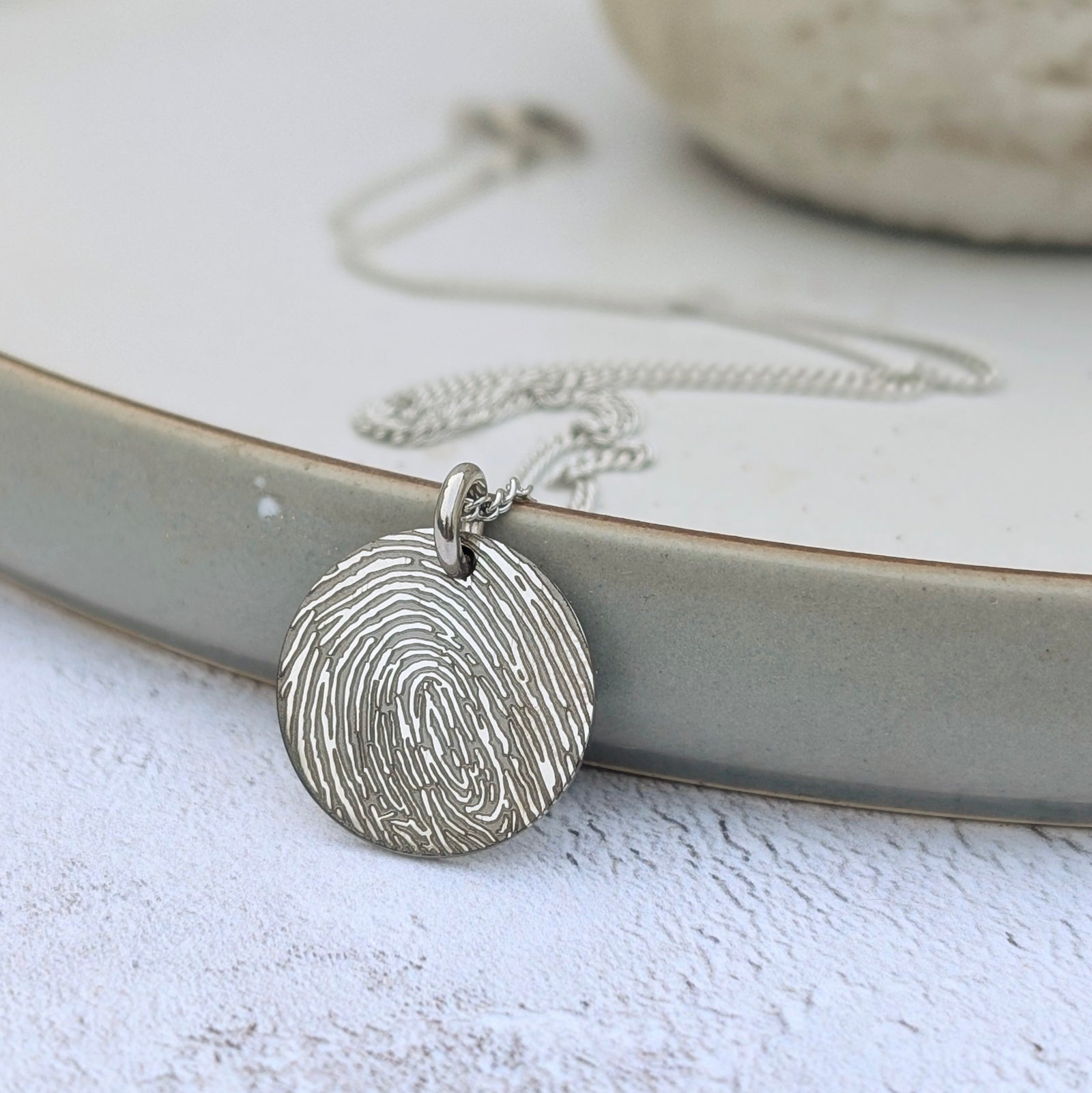 fingerprint disc charm