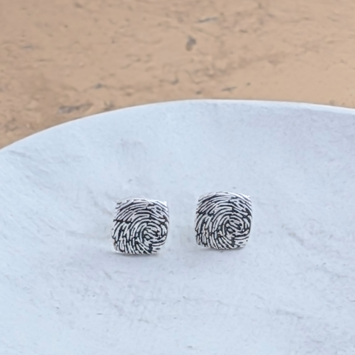 Personalised Fingerprint Cushion Stud Earrings handcrafted in sterling silver or solid gold, featuring your own unique fingerprint captured in beautiful detail.
