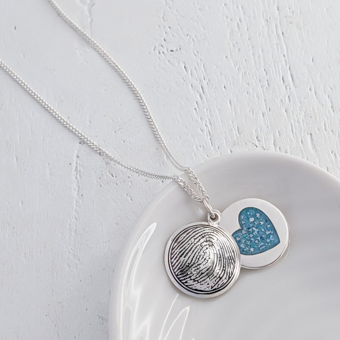 handmade silver fingerprint locket containing memorial cremation ashes