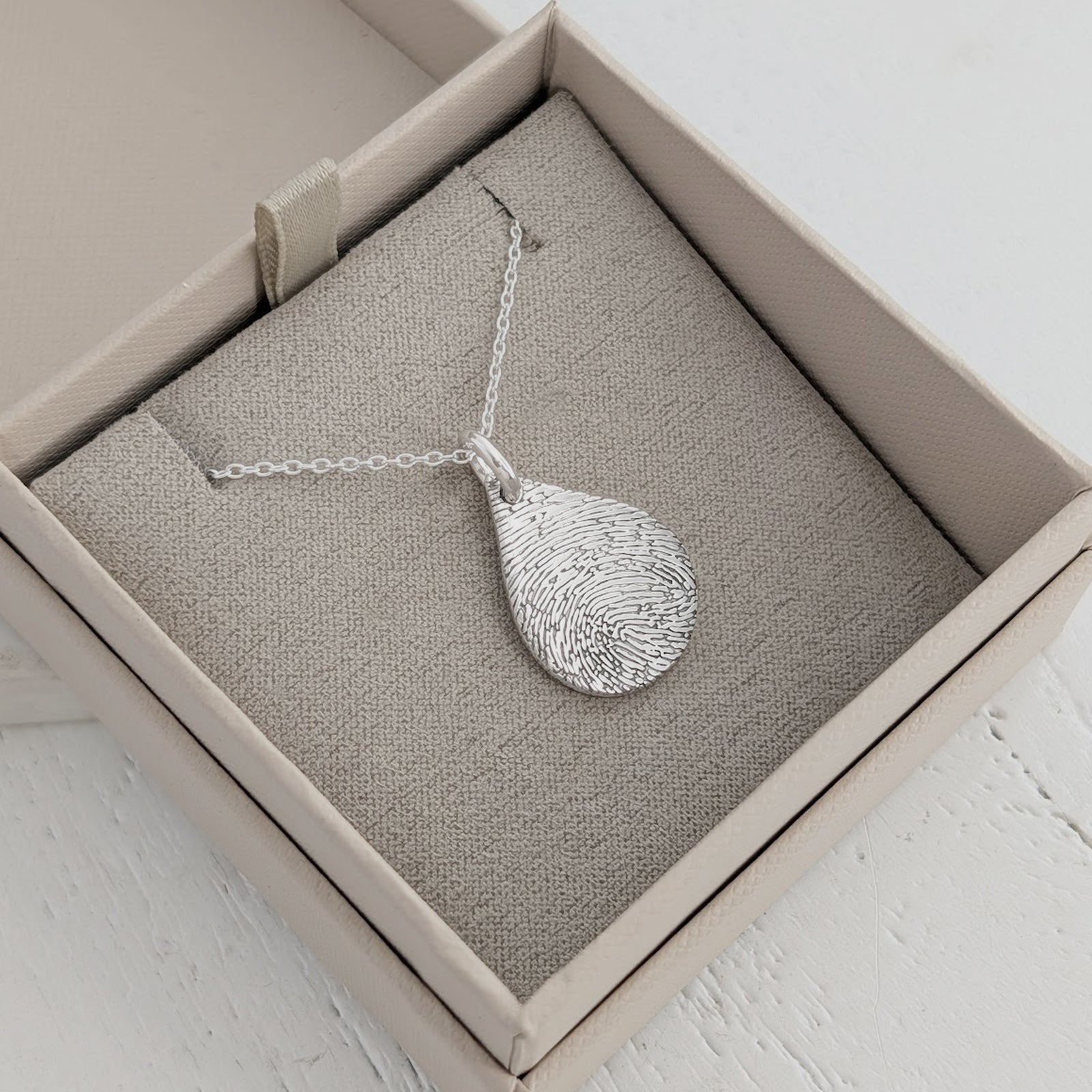 Personalised Fingerprint Teardrop Pendant – Beautiful teardrop necklace featuring your loved one's unique fingerprint captured in intricate detail. Handcrafted to order in sterling silver or gold.