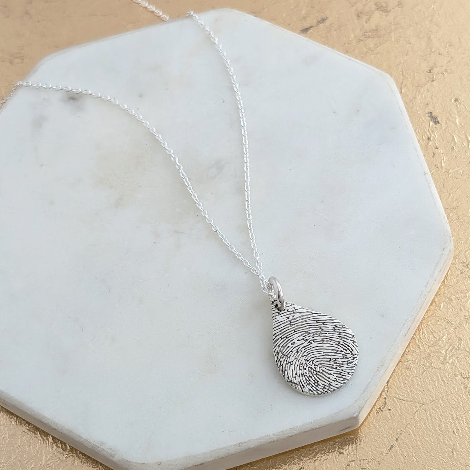 Handmade Fingerprint Droplet Pendant Necklace – Bespoke fingerprint jewellery crafted from sterling silver or solid gold. A timeless personalised necklace designed to keep treasured memories close to your heart.