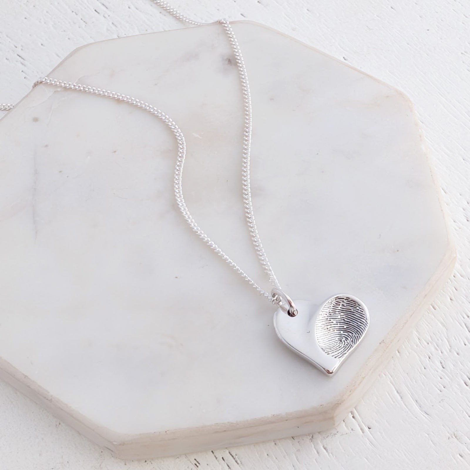 Handmade silver heart charm necklace with personlised engraved fingerprint impression