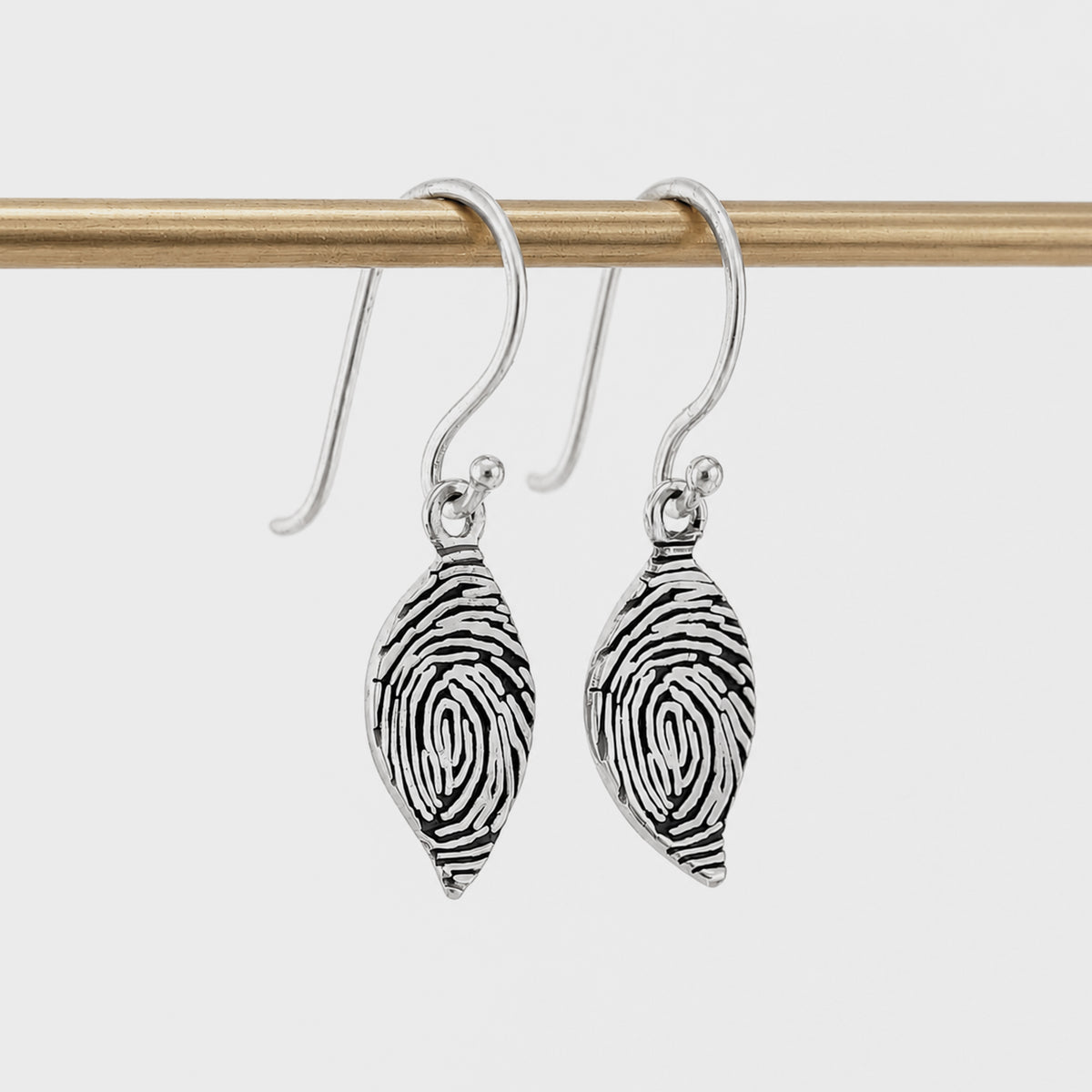 Personalised Fingerprint Leaf Earrings – Delicate leaf-shaped dangle earrings featuring your loved one's unique fingerprint engraved in beautiful detail. Available in sterling silver or gold and handcrafted to order.