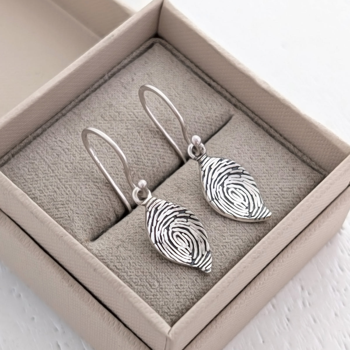 Engraved Fingerprint Leaf Jewellery Earrings – Beautiful personalised leaf dangle earrings showcasing the intricate detail of a real fingerprint. Handmade in Shropshire from sterling silver or solid gold for a lasting sentimental gift.