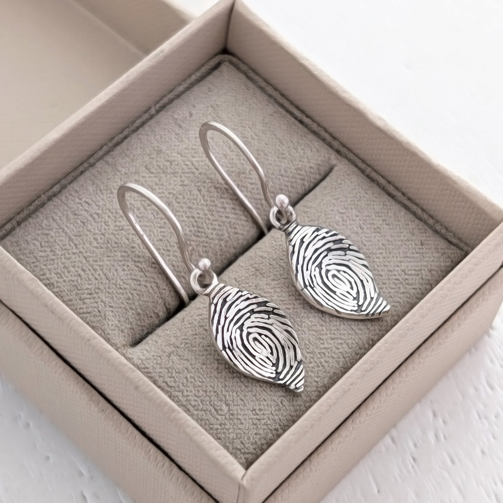 Engraved Fingerprint Leaf Jewellery Earrings – Beautiful personalised leaf dangle earrings showcasing the intricate detail of a real fingerprint. Handmade in Shropshire from sterling silver or solid gold for a lasting sentimental gift.