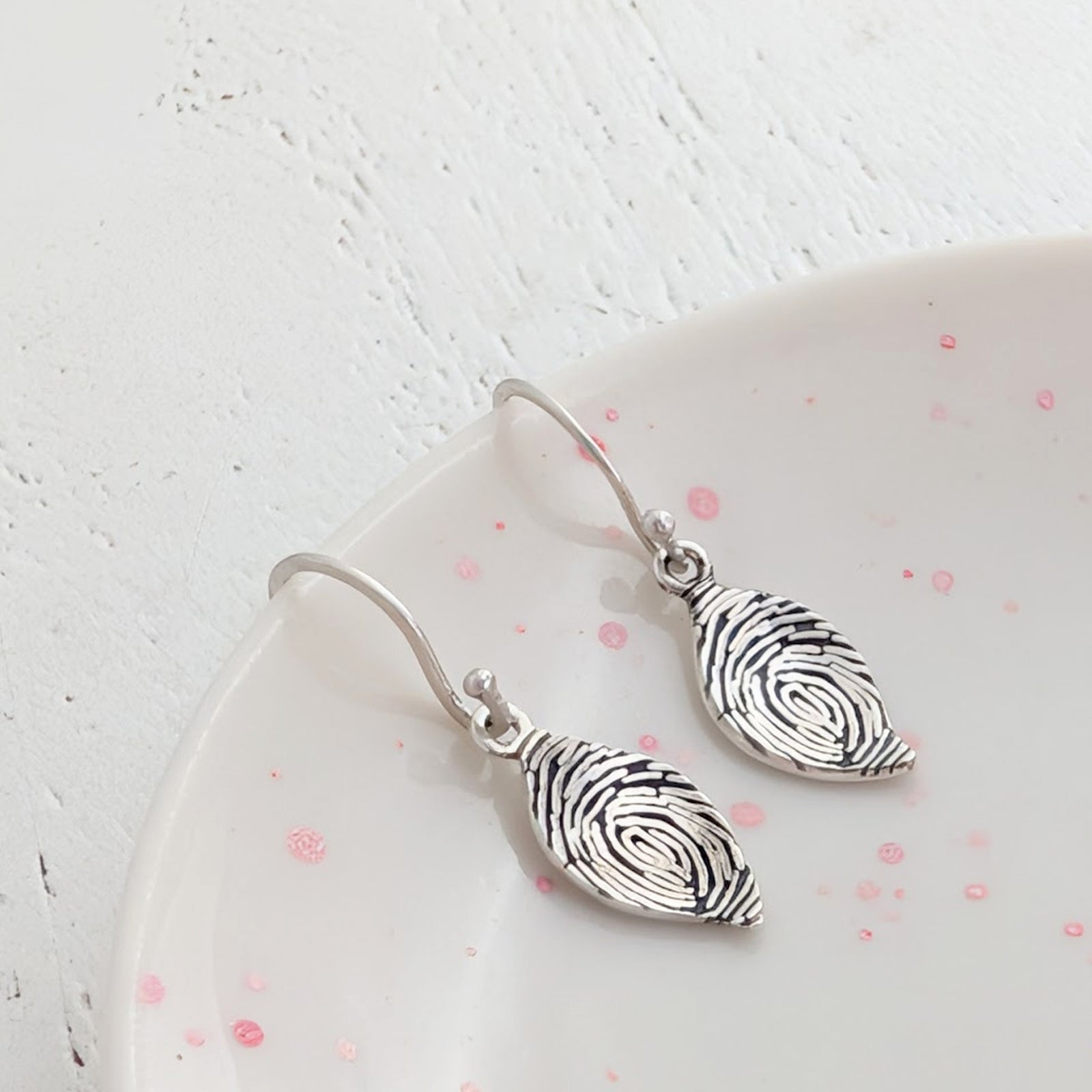 Handmade Leaf Fingerprint Drop Earrings – Bespoke memorial and keepsake earrings engraved with a genuine fingerprint. Crafted in sterling silver or gold with graceful leaf-shaped drops and classic ear hooks.