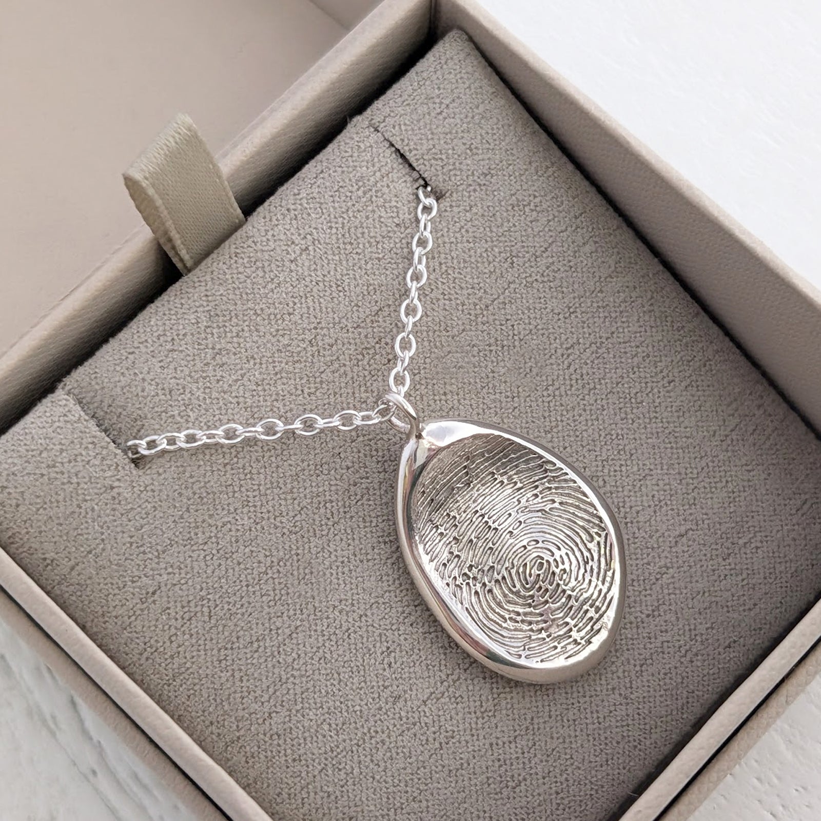 Handmade Organic Fingerprint Pendant in silver or gold, individually crafted using your own fingerprint. A unique memorial jewellery piece and sentimental keepsake necklace designed to hold precious memories close.