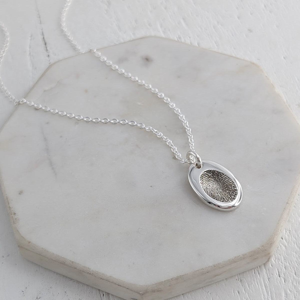 Silver fingerprint impression oval charm