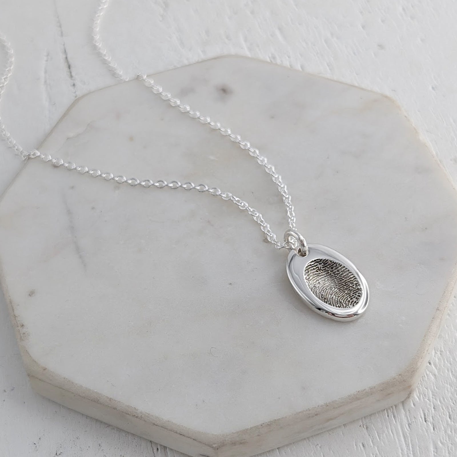 Silver fingerprint impression oval charm