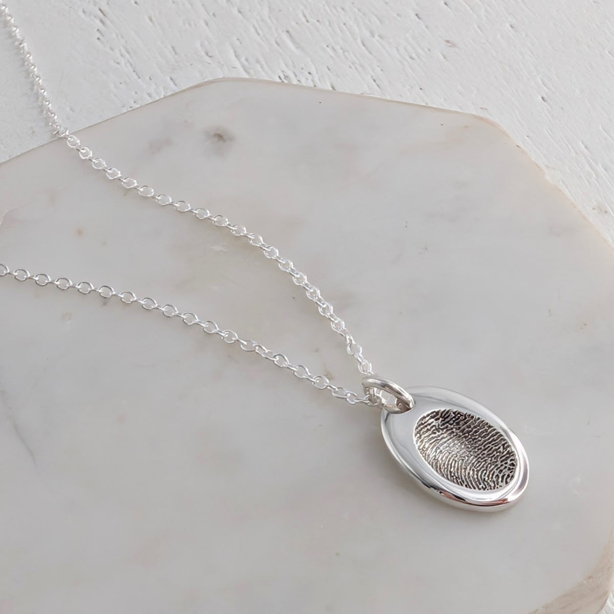 Silver oval charm personalised with your engraved fingerprints