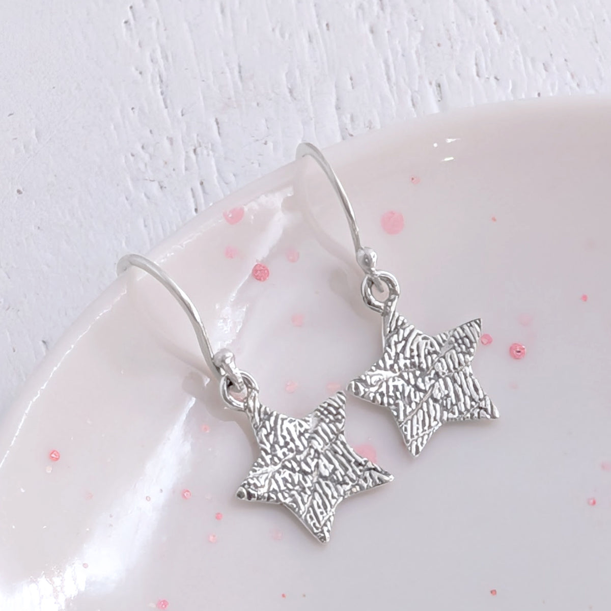 Fingerprint Star Dangle Earrings in Silver or Gold – Personalised star drop earrings engraved with a real fingerprint. Handmade in sterling silver or solid gold, creating a meaningful keepsake jewellery gift.