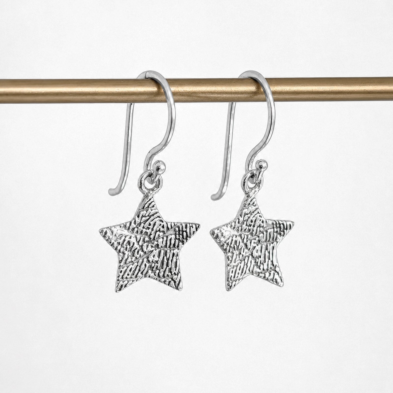 Personalised Fingerprint Star Earrings – Elegant star-shaped dangle earrings featuring your loved one's unique fingerprint engraved in beautiful detail. Available in sterling silver or gold and handcrafted to order.