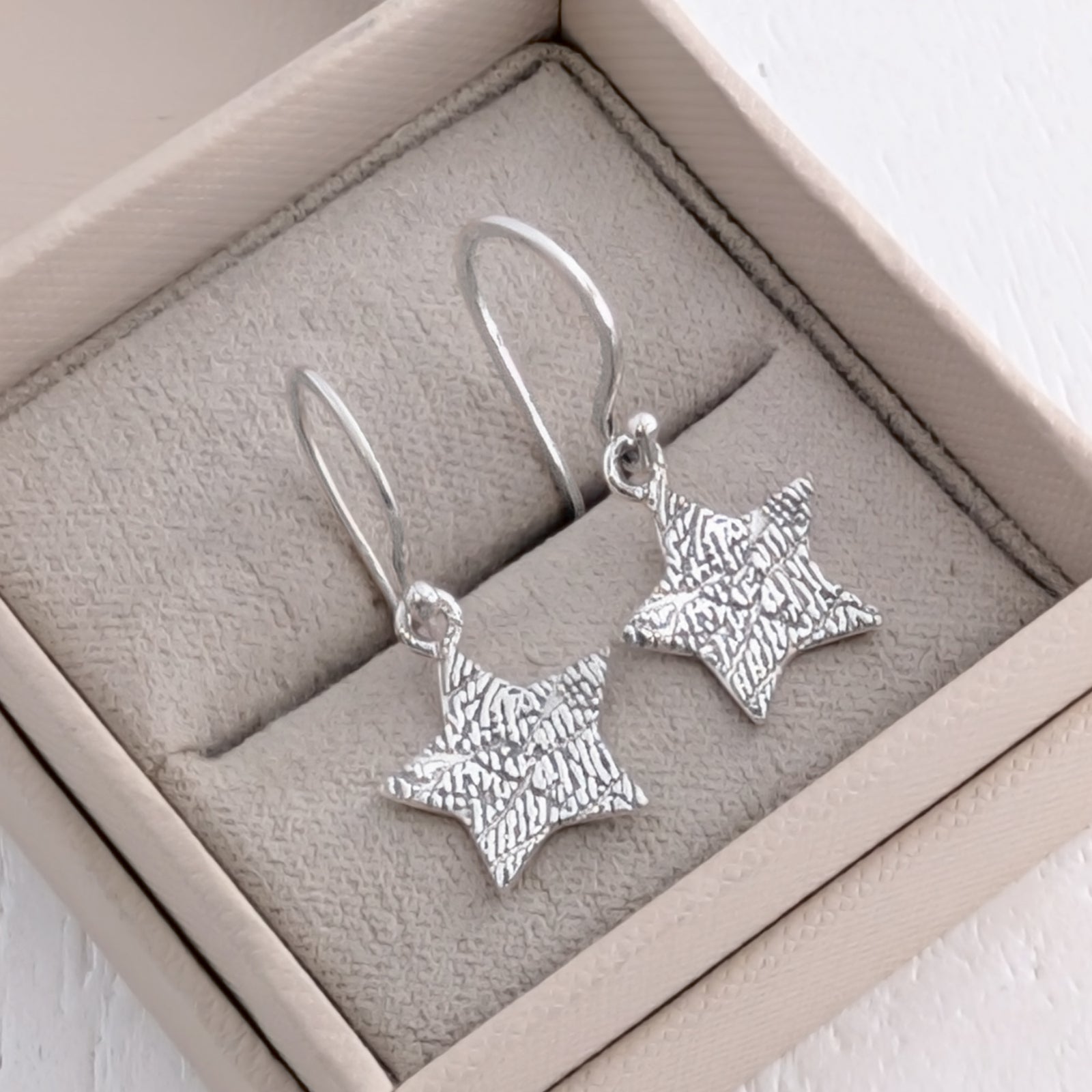Handmade Fingerprint Star Drop Earrings – Bespoke memorial and keepsake earrings engraved with a genuine fingerprint. Crafted in sterling silver or gold with delicate star charms and classic ear hooks.