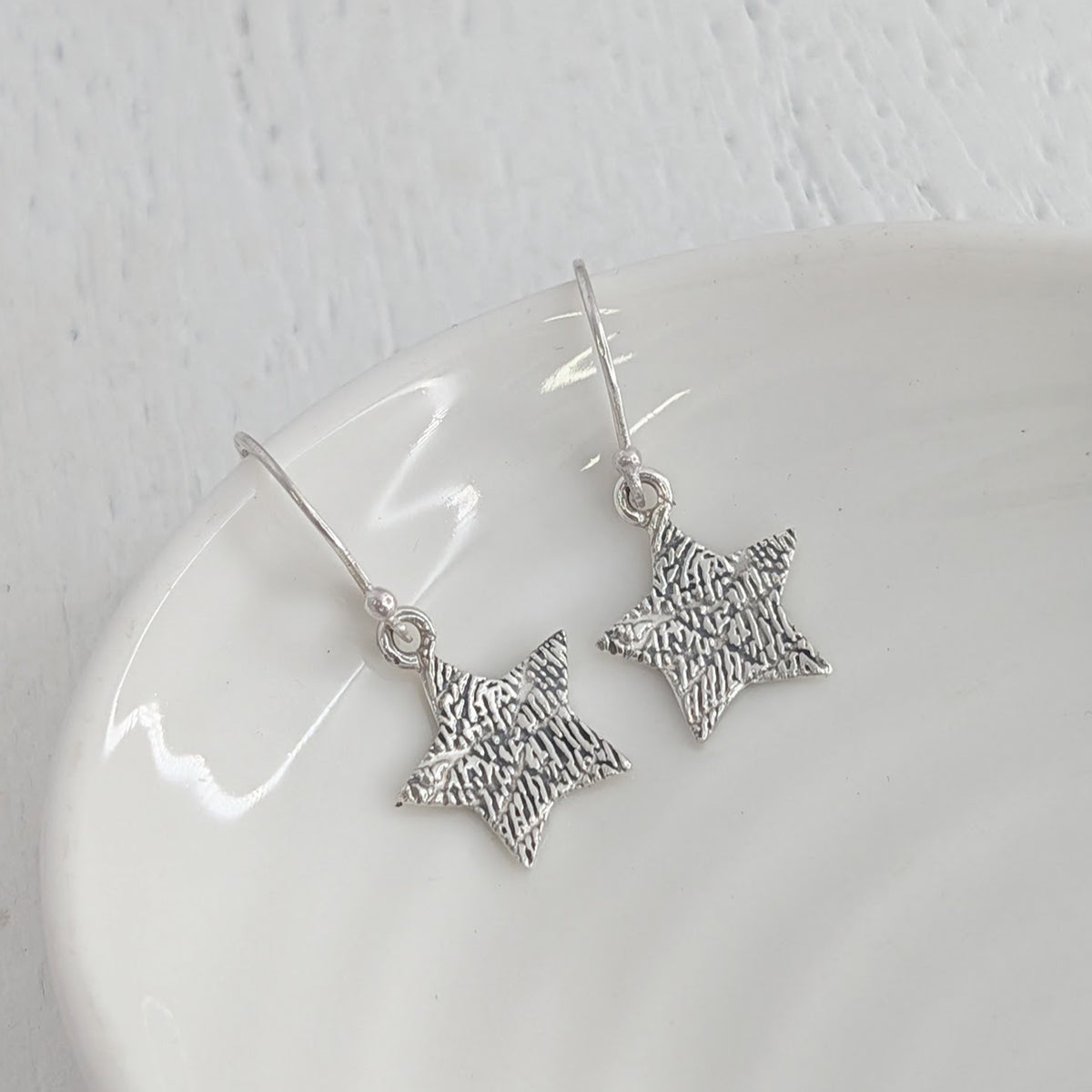 Engraved Fingerprint Star Jewellery Earrings – Beautiful personalised star earrings showcasing the intricate detail of a real fingerprint. Handmade in Shropshire from sterling silver or solid gold as a lasting memorial or sentimental gift.