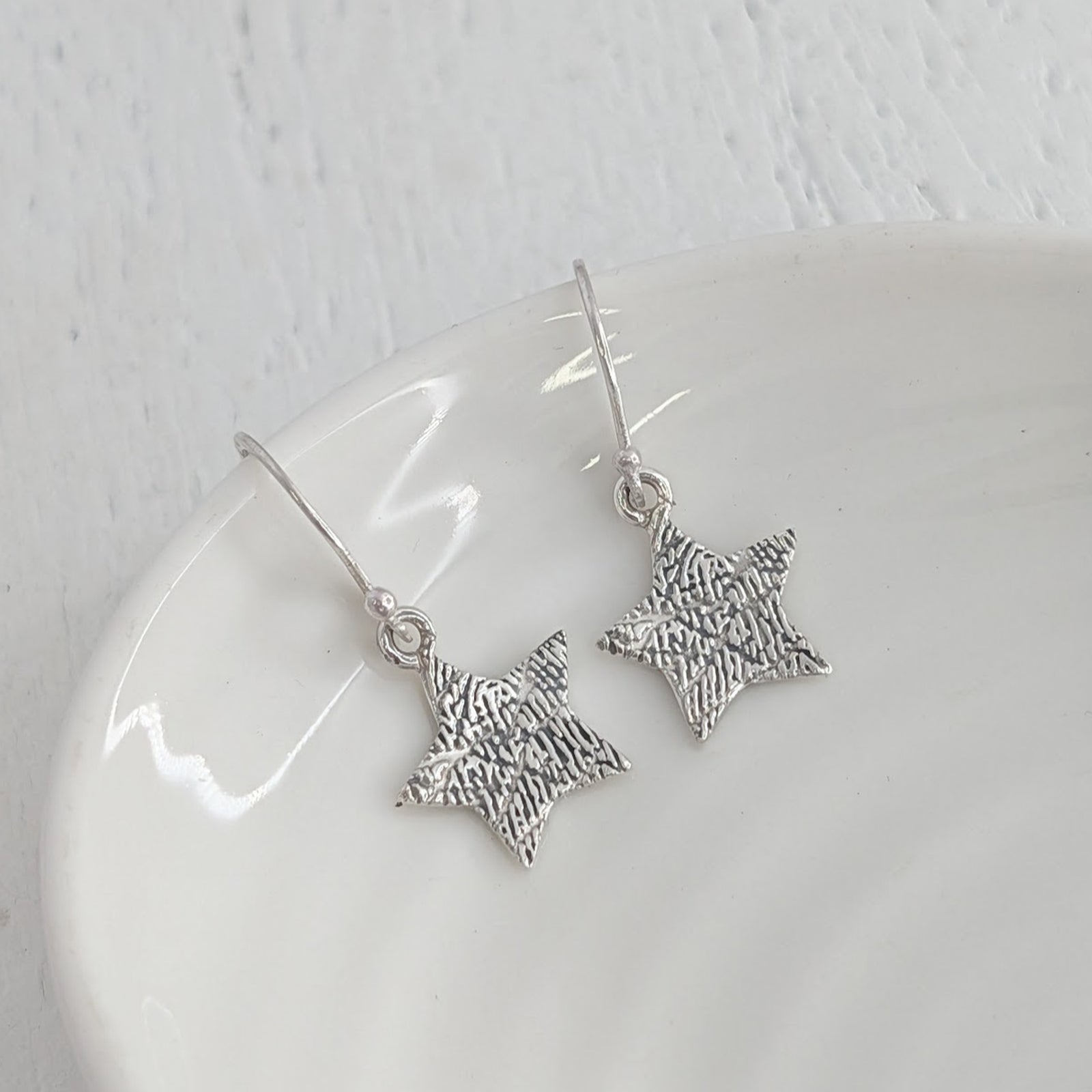 Engraved Fingerprint Star Jewellery Earrings – Beautiful personalised star earrings showcasing the intricate detail of a real fingerprint. Handmade in Shropshire from sterling silver or solid gold as a lasting memorial or sentimental gift.
