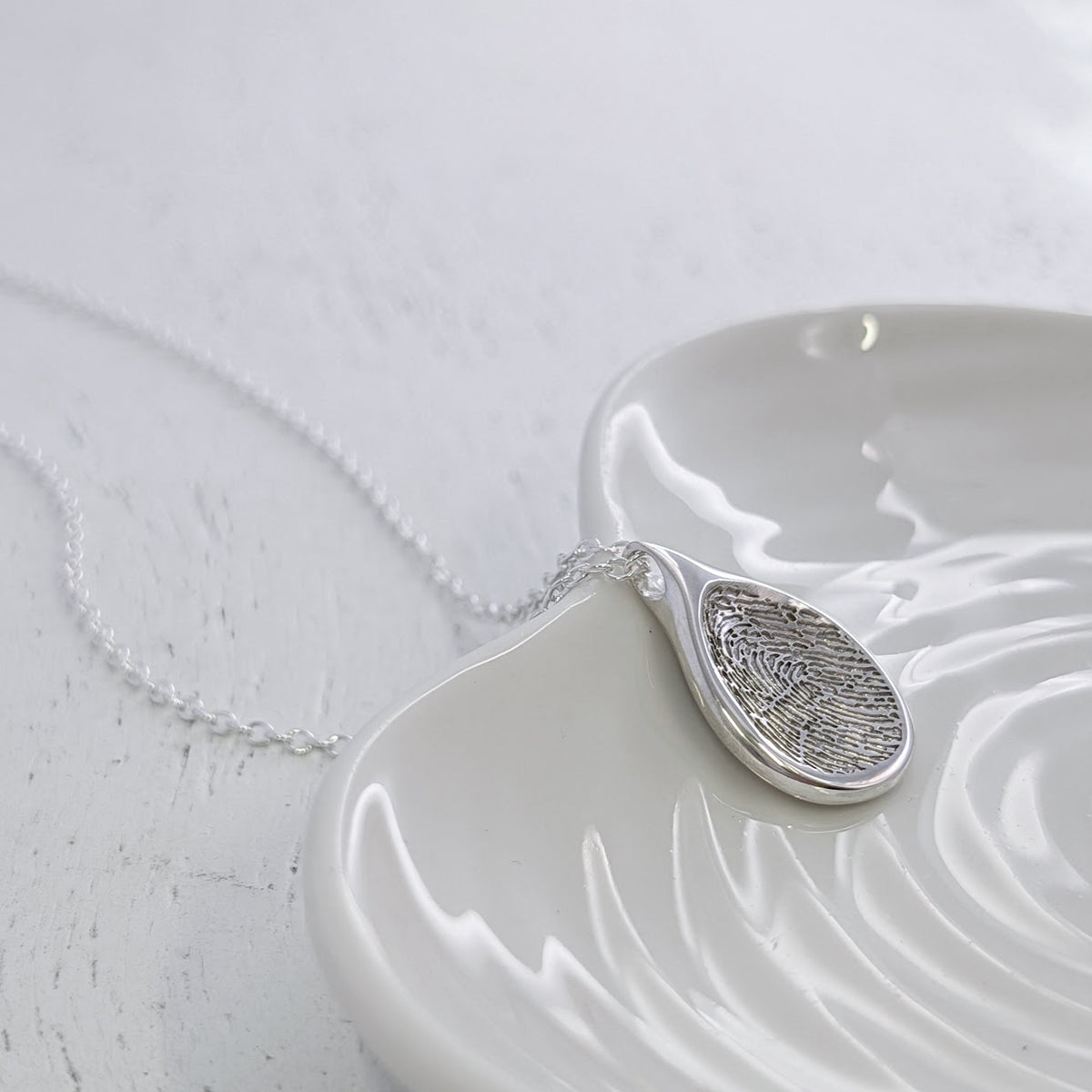 Organic Teardrop Fingerprint Necklace crafted from sterling silver or solid gold. Designed to showcase a genuine fingerprint in exquisite detail, creating a unique personalised jewellery gift filled with meaning and connection.