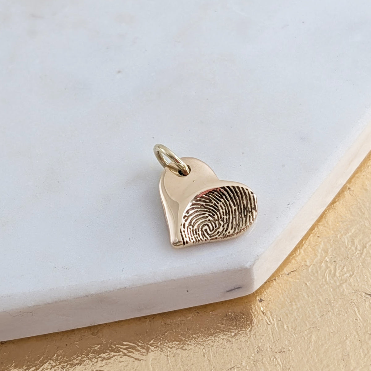 Gold fingerprint heart charm
