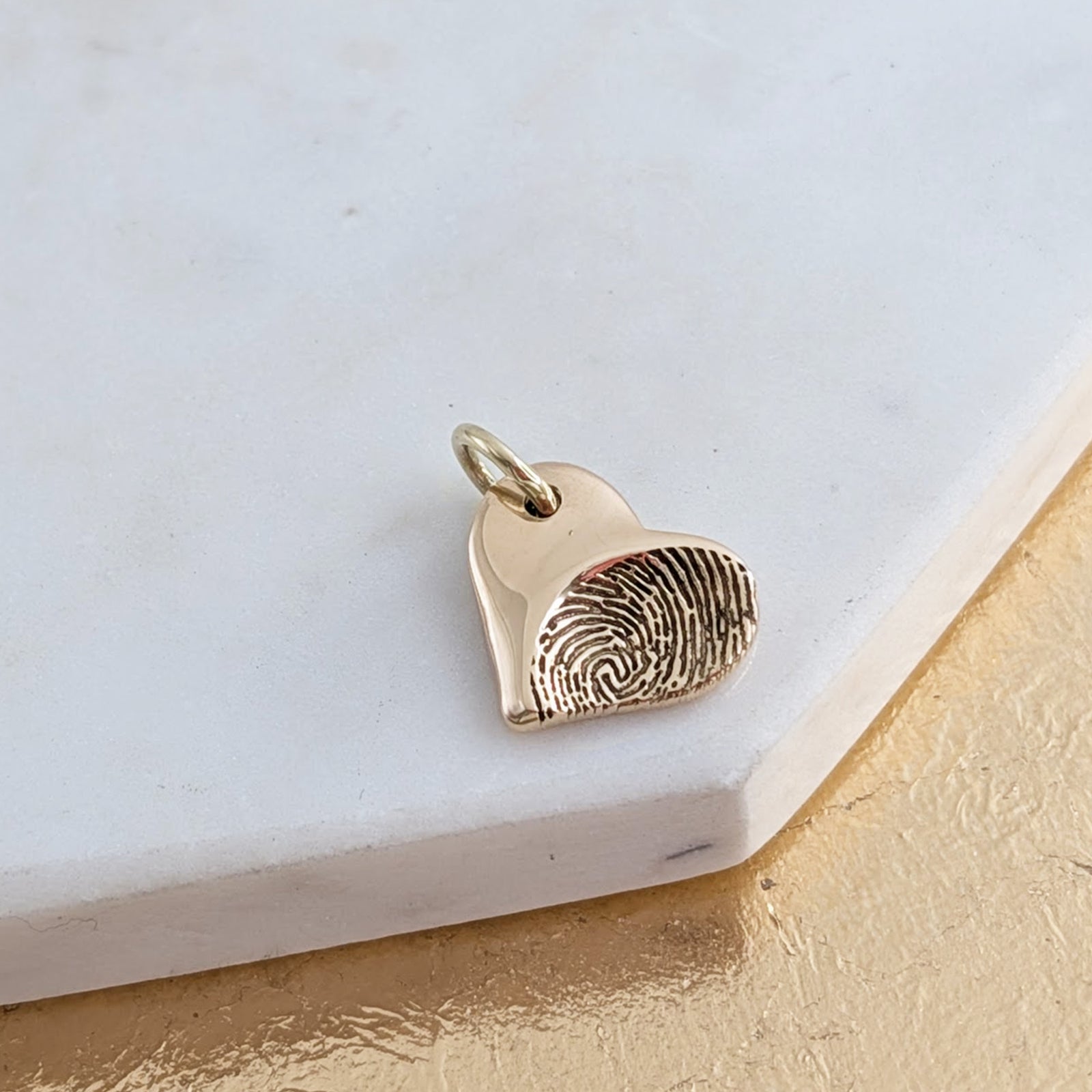 Gold fingerprint heart charm
