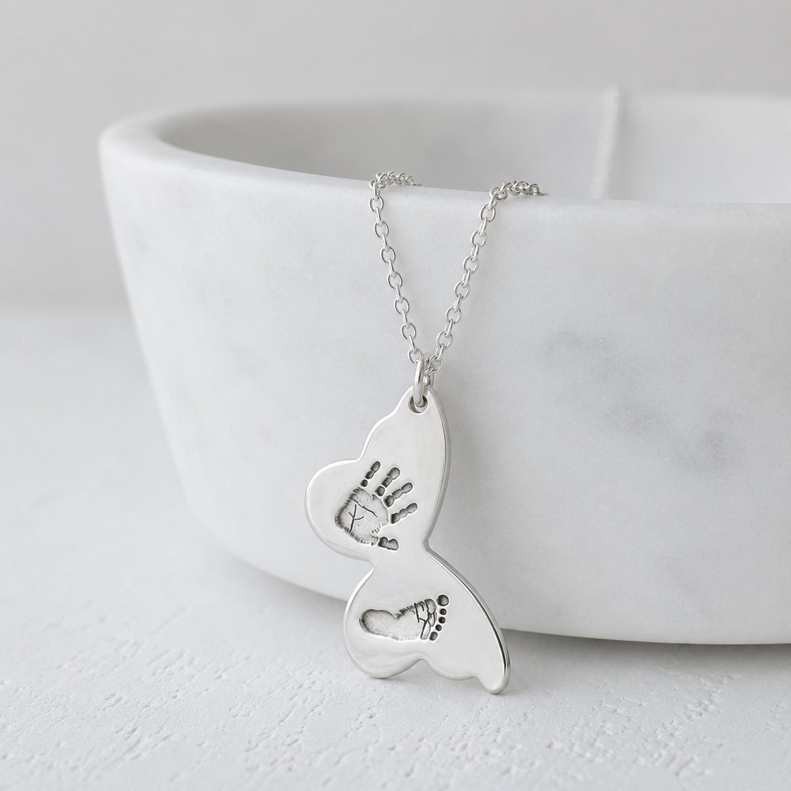 personalised silver butterfly necklace engraved with baby's handprint and footprint