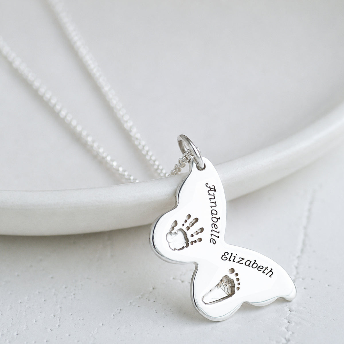 handprint and footprint butterfly necklace in silver and gold