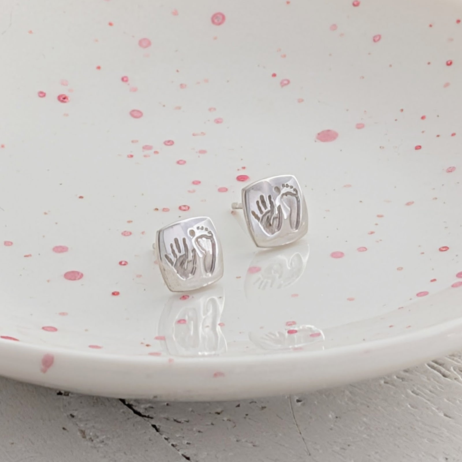 Square cushion handprint and footprint stud earrings, individually handmade in silver or gold and engraved with your child's real prints to create a treasured keepsake.