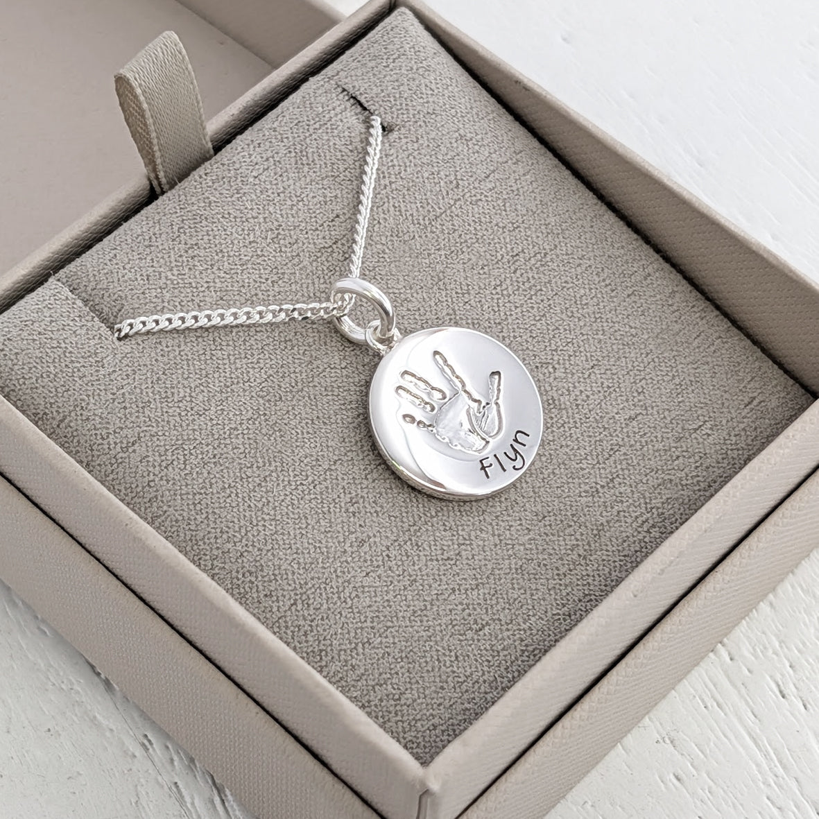 Silver handprint round charm with silver polished handprint