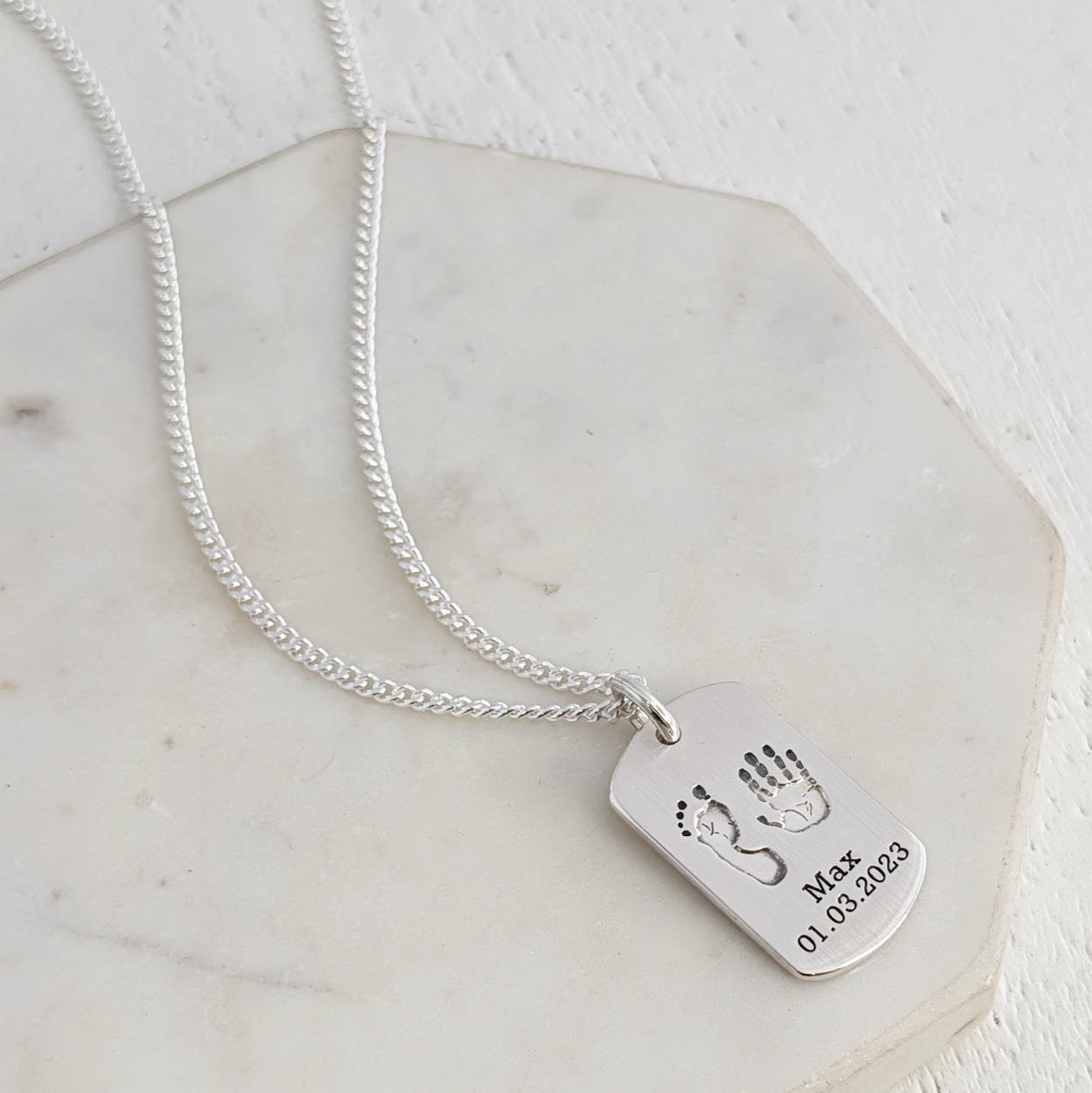 Personalised dog tag engraved with childs own handprint and footprint