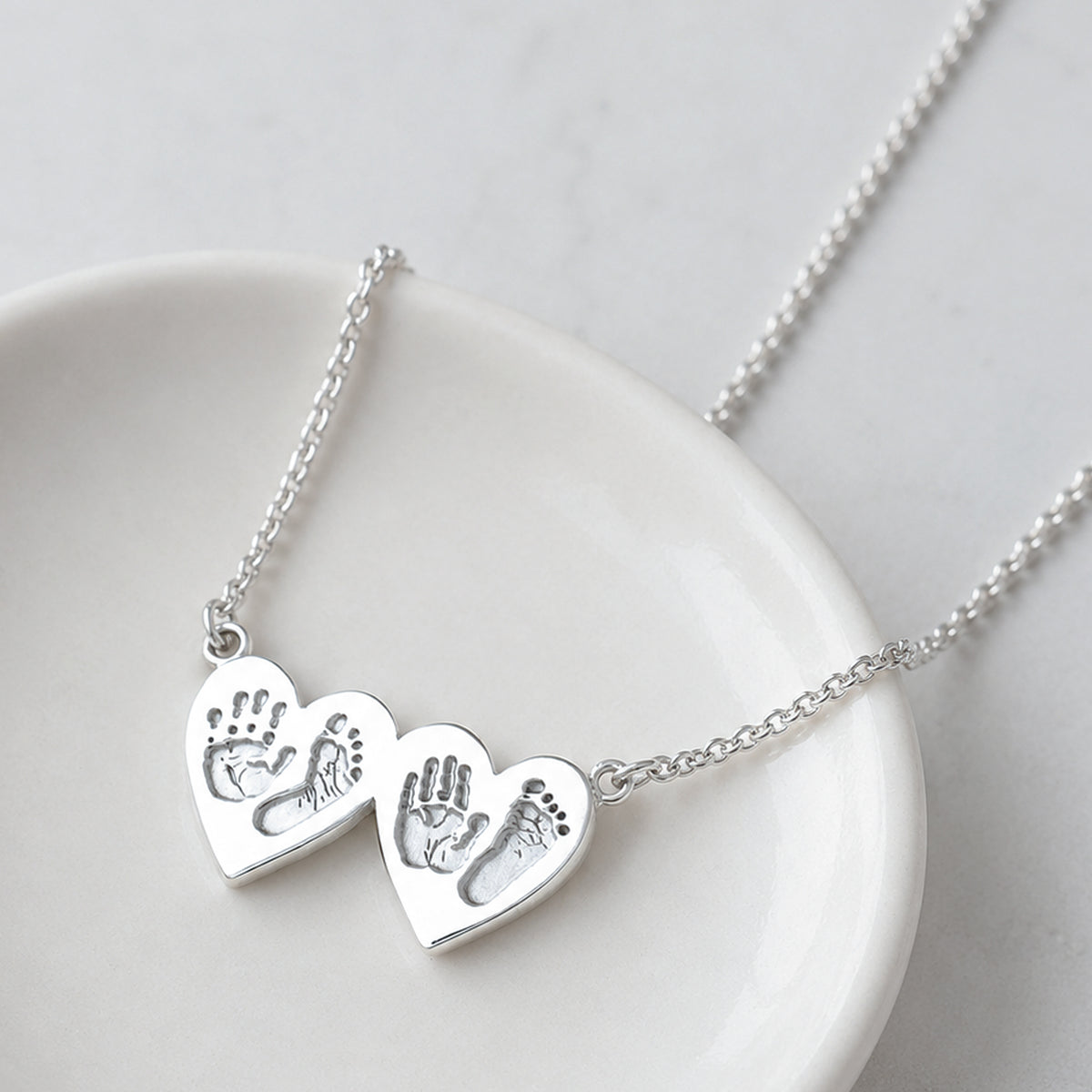 baby handprint and footprint double heart necklace in silver or gold
